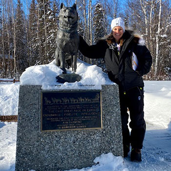 Dr. Preston standing next to a statue of Balto