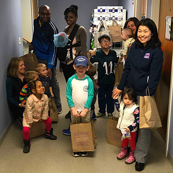 Dr. Ai with a group of young visitors