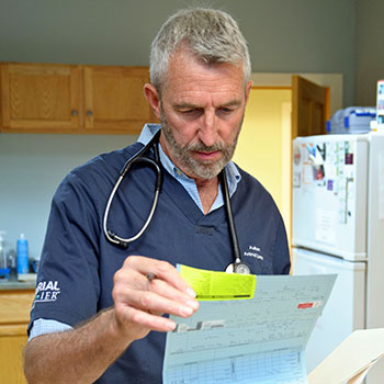 Dr. Kinney looking over a patient's medical records